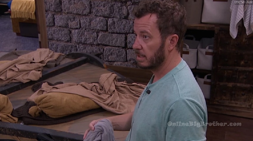 A man in a green shirt talking in the Big Brother house bedroom, captured from the live feeds