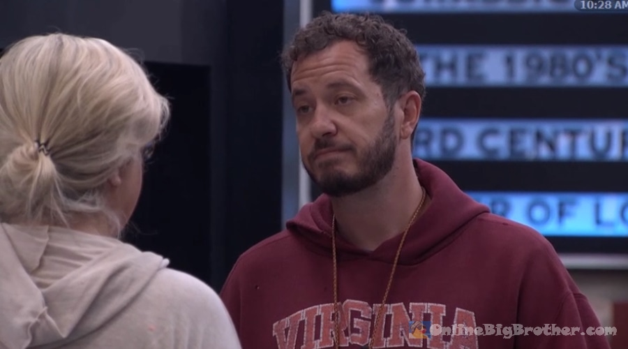 Devens in a Virginia hoodie listening to Angela during their 10:25 am conversation in the Big Brother house