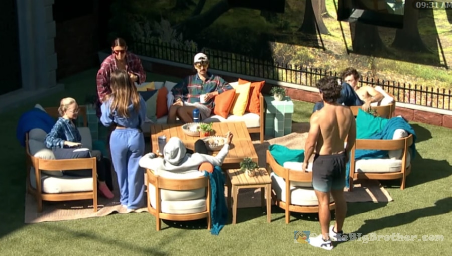 Houseguests gathered in the Big Brother backyard at 9:31 AM, milling around the outdoor seating area