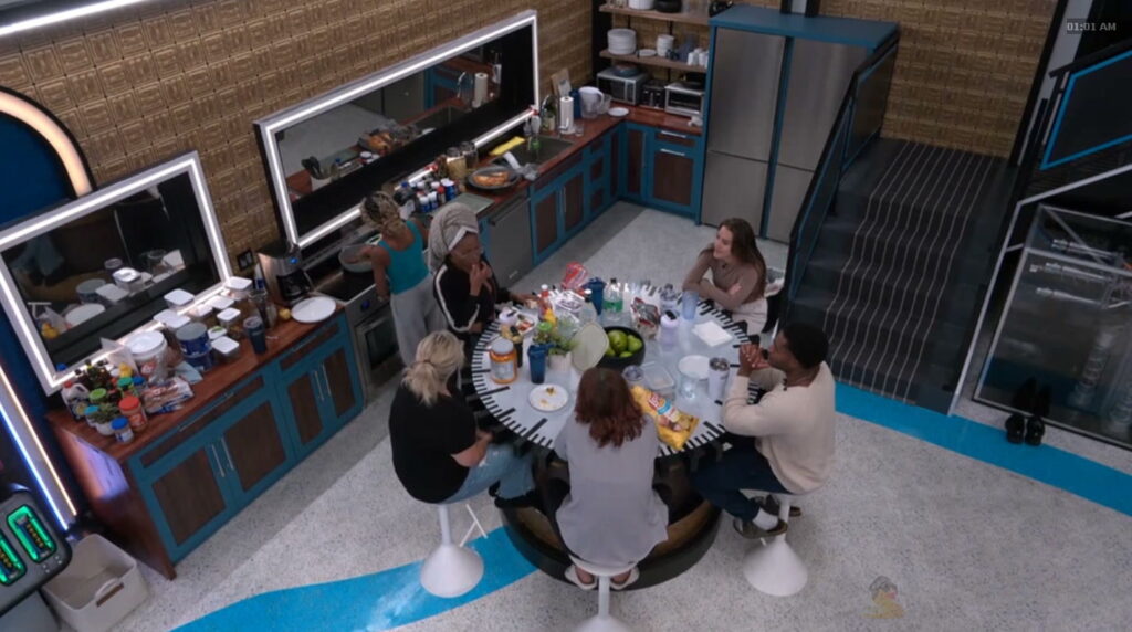 Dee, CHUNK, Angela and HAley crowded around LaTrice in the kitchen .