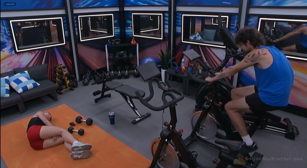 Mallory doing core work on the gym mat while Barrett talks game