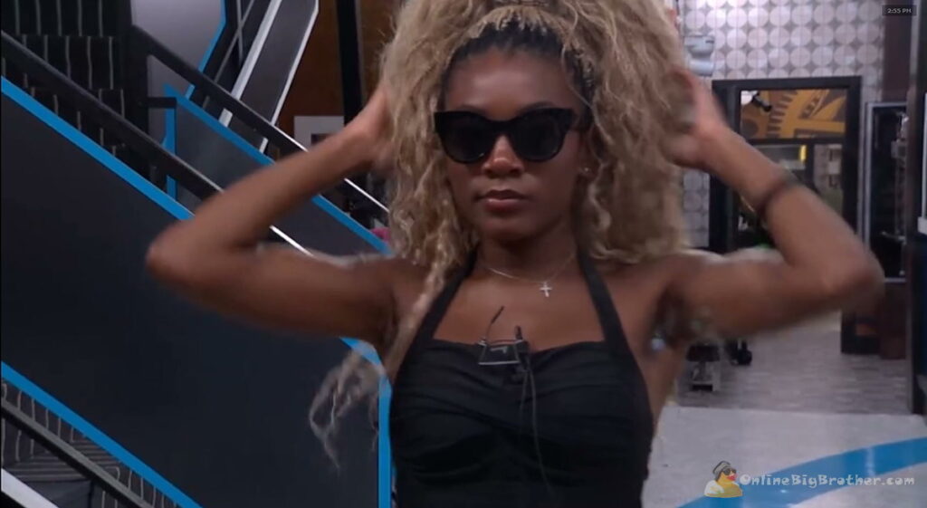 BB28 Taylor fixing her hair and sunglasses in front of the mirror.